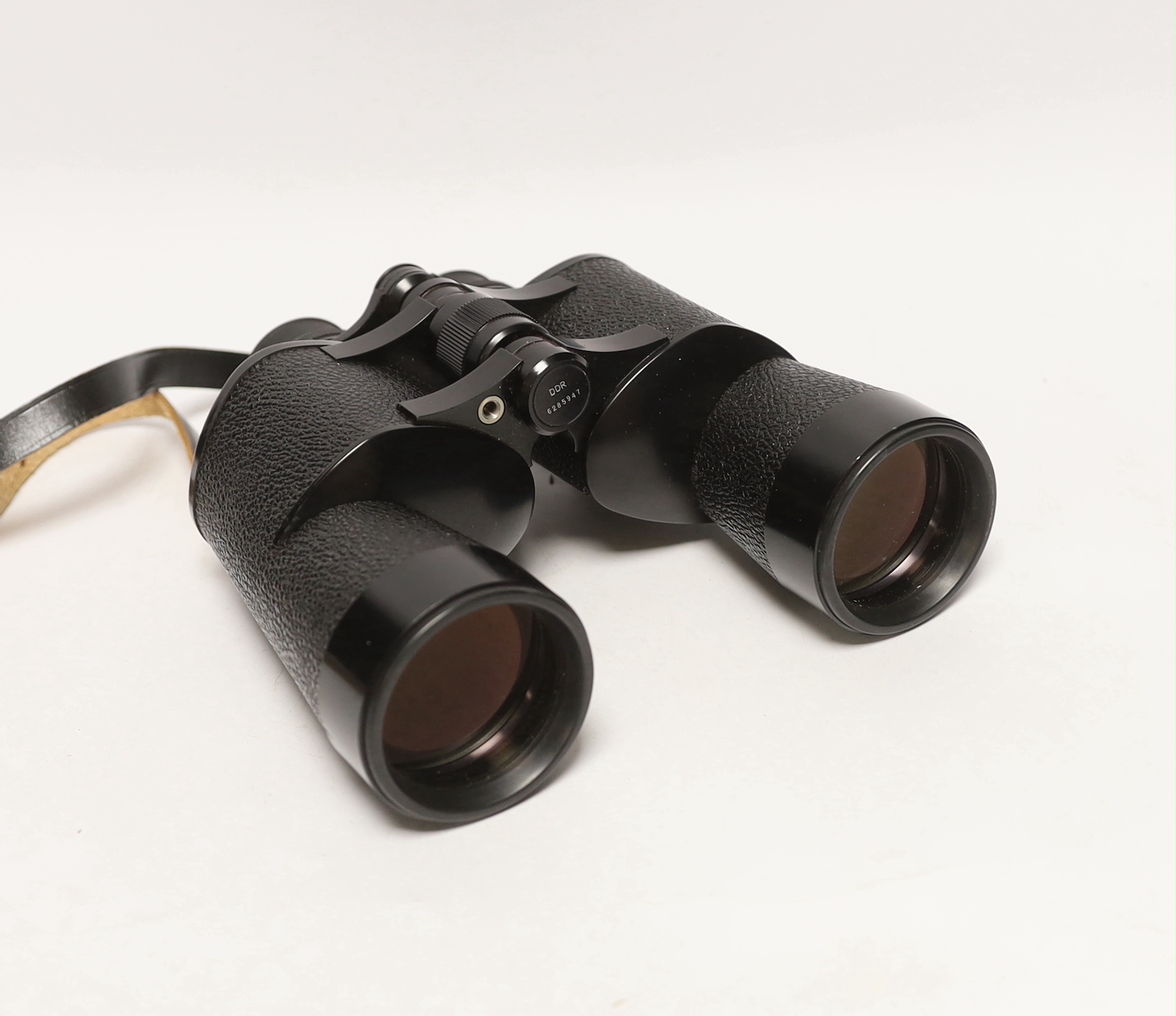 A pair of Zeiss Octarem 8X50B binoculars in a leather case with strap